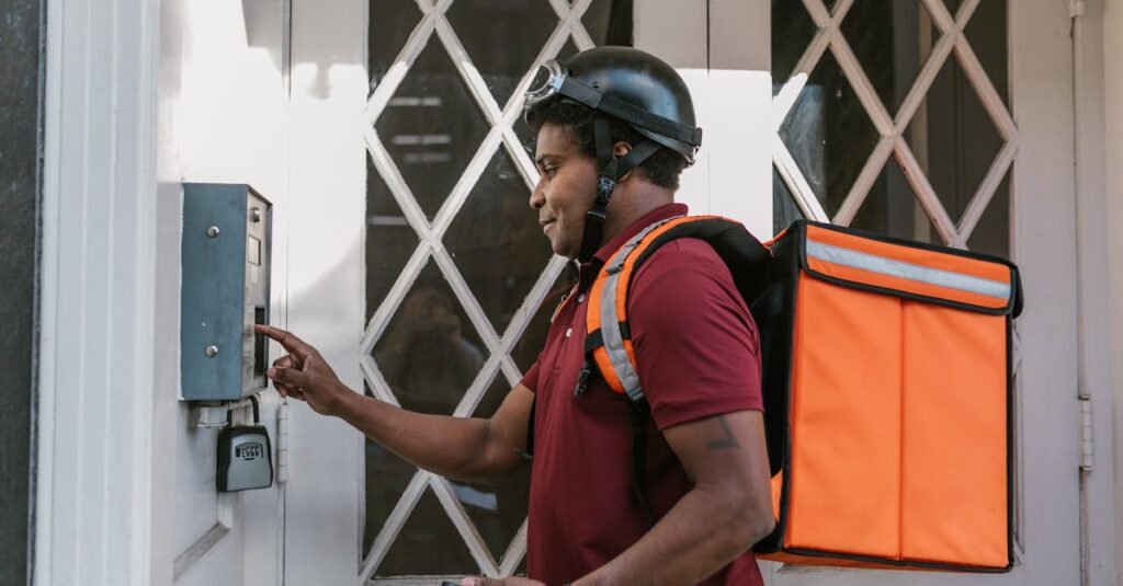 Delivery person with insulated bag pressing doorbell at entrance, providing home delivery service.